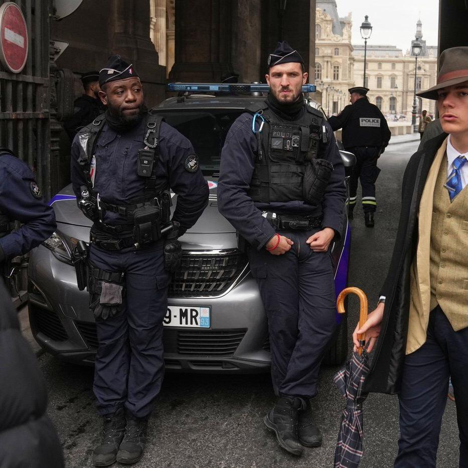 Inspector Clouseau? The mystery man in an AP photo after the Louvre jewel heist creates a buzz